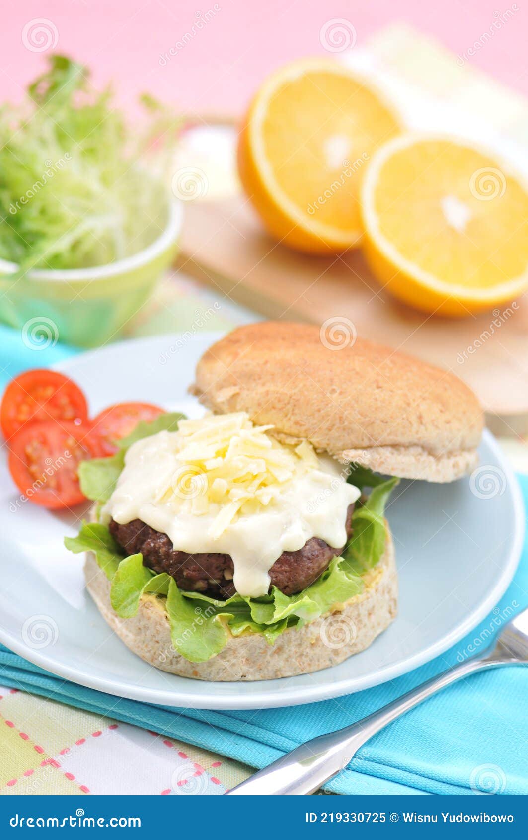 grilled beef burger with cheese sauce and vegetables
